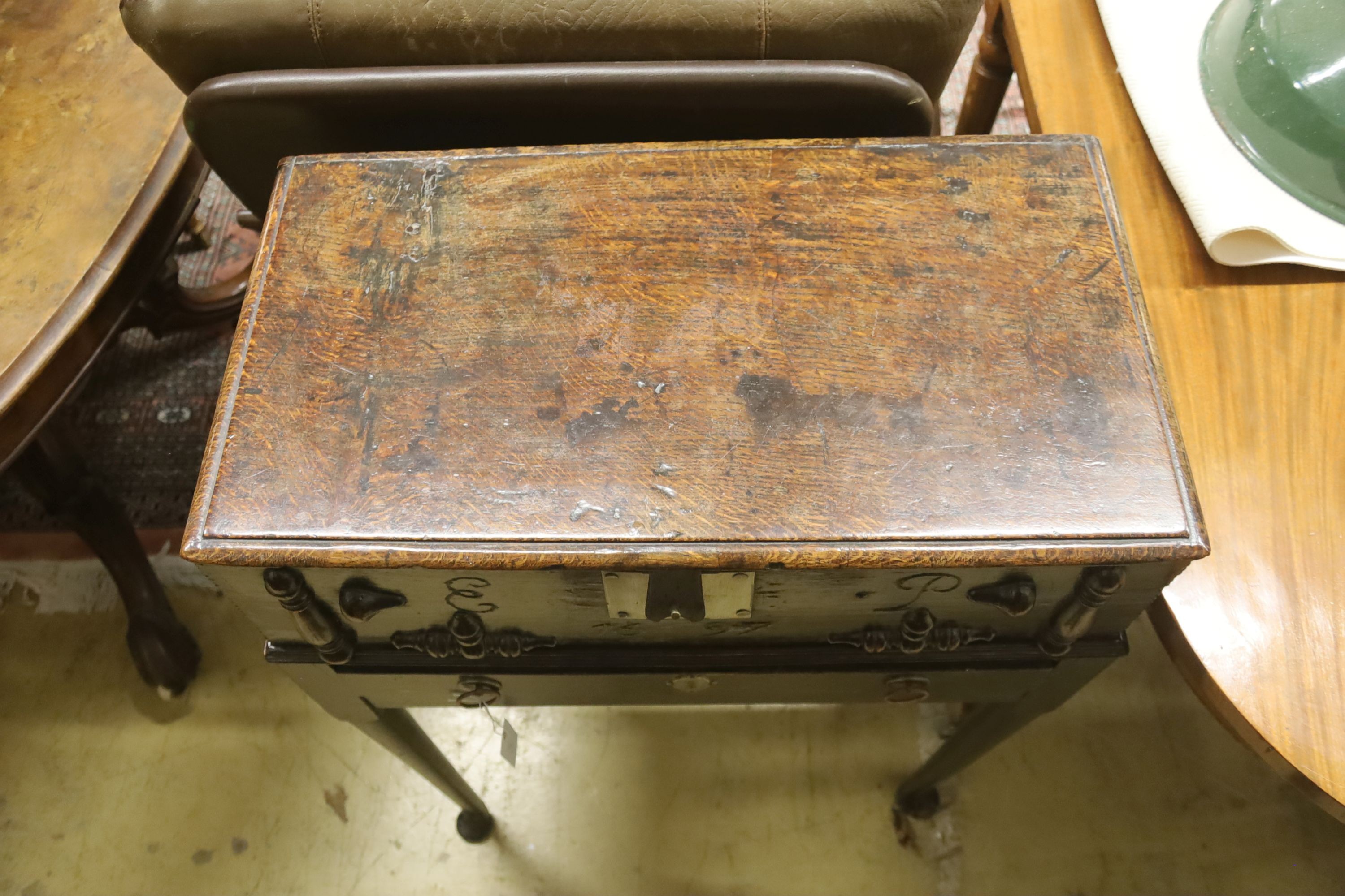 A late 17th century oak bible box, monogrammed EP, dated 1697, raised on a stand, width 62cm, depth 33cm, height 87cm